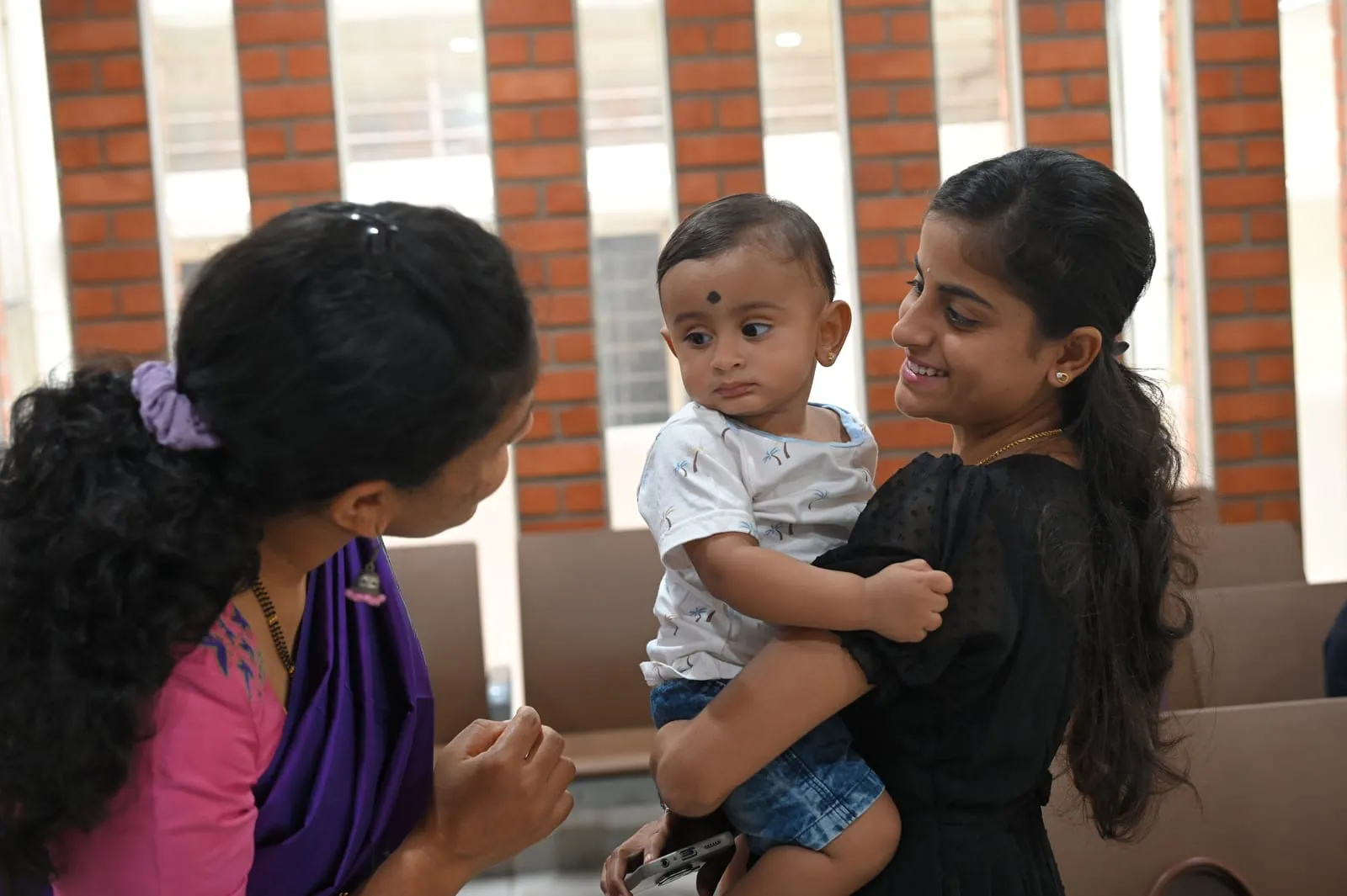 A mother and her baby being welcomed at Suprama Diagnostics